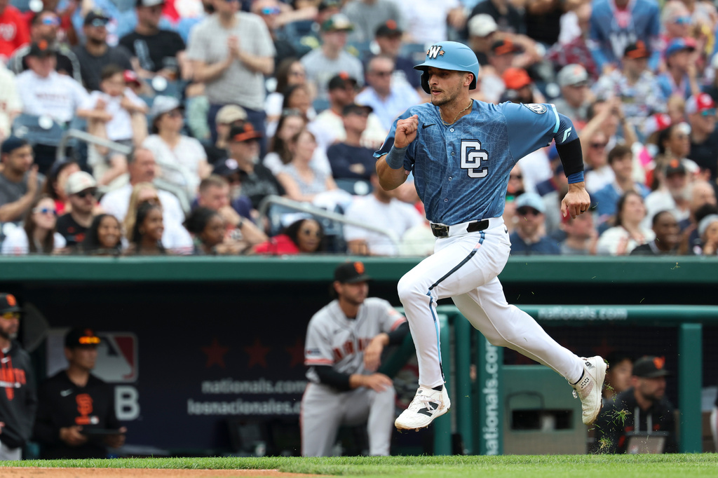Washington Nationals' Drew Millas runs to score on a single hit by Luis García Jr. off San Francisco Giants pitcher Adrian Houser during the second inning of a baseball game, Saturday, April 18, 2026, in Washington. (AP Photo/Terrance Williams)