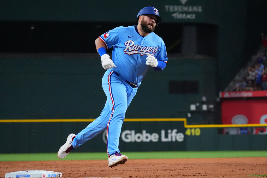 Texas Rangers' Jake Burger runs past third base after hitting a home run during the third inning of a baseball game against the Detroit Tigers, Sunday, July 5, 2026, in Arlington, Texas. (AP Photo/LM Otero)