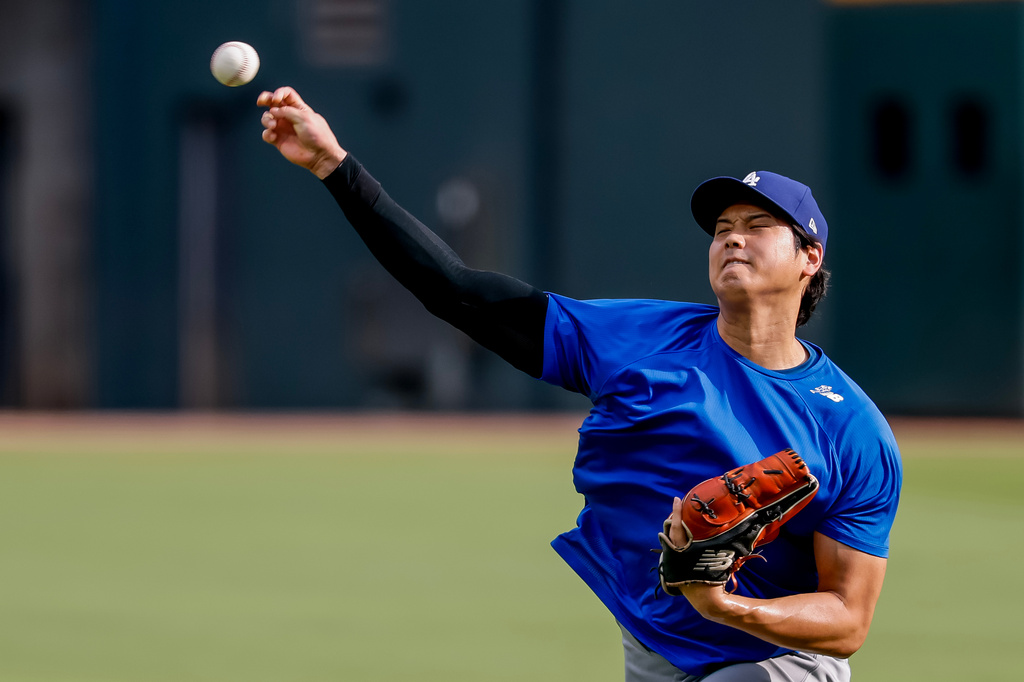 Los Angeles Dodgers pitcher Shohei Ohtani throws a practice session in the outfield before a baseball game against the Atlanta Braves, Thursday, Aug. 27, 2026, in Atlanta. (AP Photo/Erik S. Lesser)
