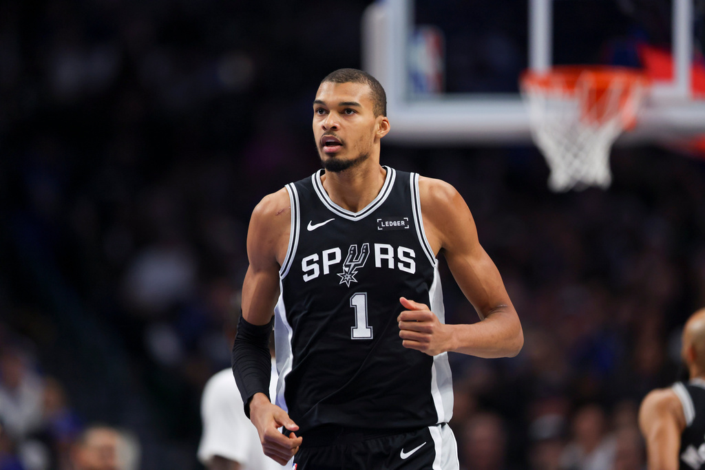San Antonio Spurs forward Victor Wembanyama (1) runs the court in the first half of an NBA basketball game against the Dallas Mavericks, Thursday, Feb. 5, 2026, in Dallas. (AP Photo/Gareth Patterson)