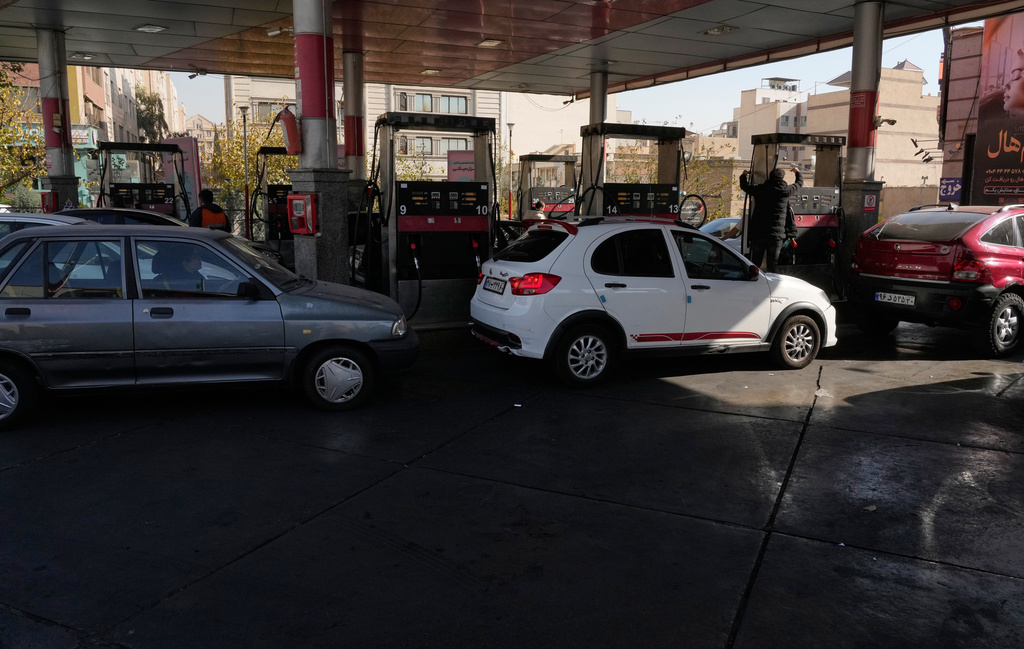 People fill their cars at a gas station in Tehran, Iran, Thursday, Nov. 27, 2025. (AP Photo/Vahid Salemi)