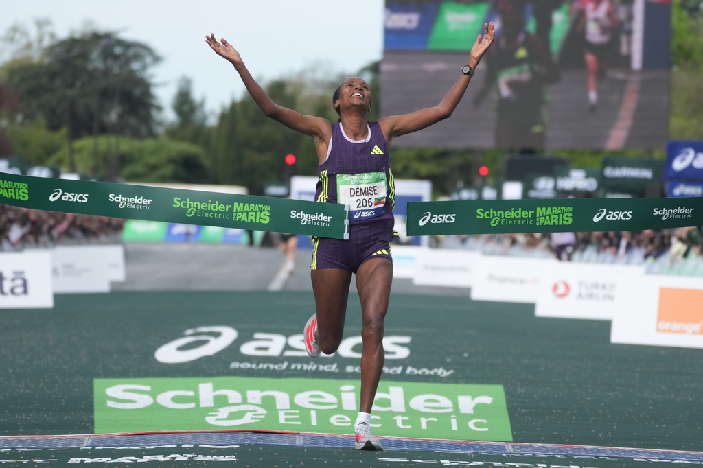 Ethiopia's Shure Demise crosses the finish line to win the women's race of the Paris marathon, in Paris, Sunday, April 12, 2026. (AP Photo/Thibault Camus)