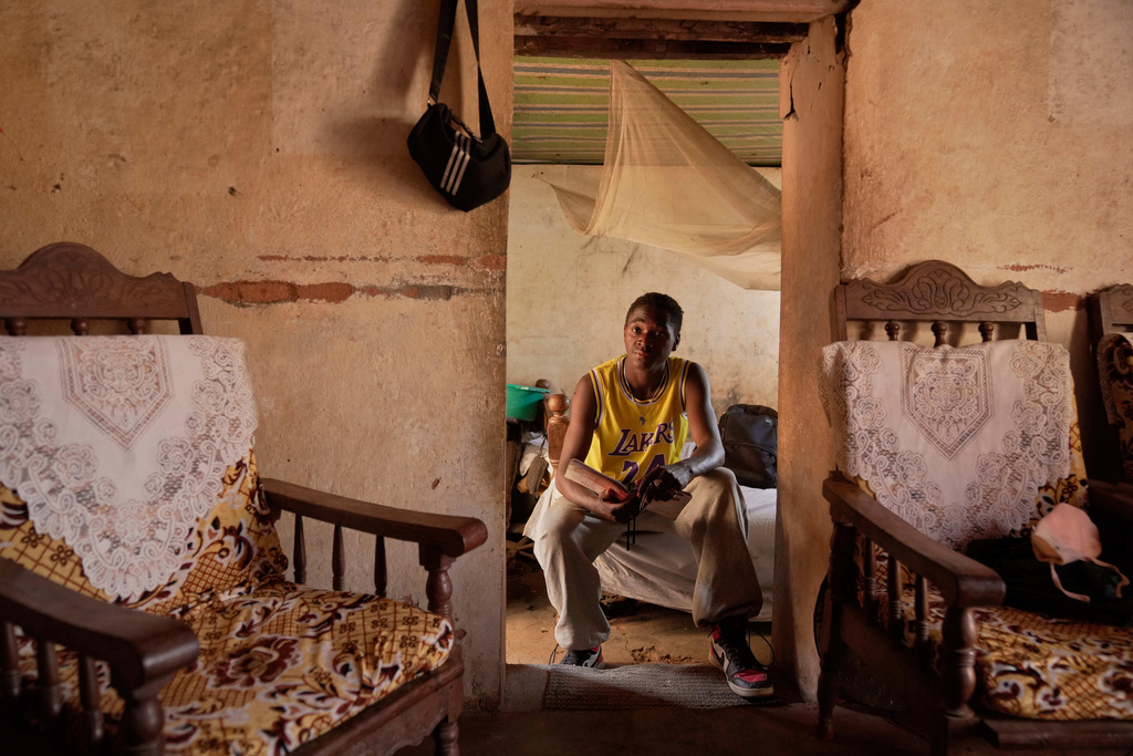 Donah Falia, a 20-year-old student pursuing an accounting course at ABC College, sits inside his aunt's house in Anosimahavelona informal settlement in Antananarivo, Madagascar, Thursday, Oct. 16, 2025. (AP Photo/Brian Inganga)