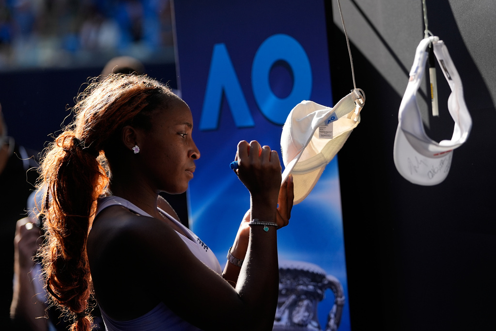 Coco Gauff of the U.S. signs autographs after defeating Karolina Muchova of the Czech Republic in their fourth round match at the Australian Open tennis championship in Melbourne, Australia, Sunday, Jan. 25, 2026. (AP Photo/Asanka Brendon Ratnayake)