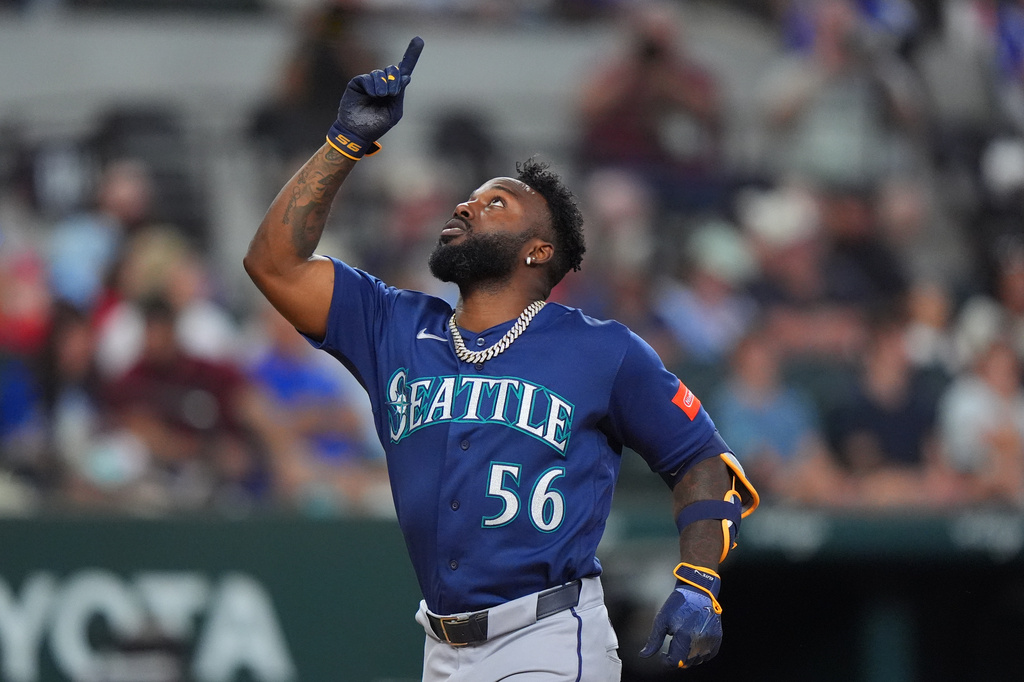Seattle Mariners' Randy Arozarena celebrates his home run during the seventh inning of a baseball game against the Texas Rangers, Sunday, July 26, 2026, in Arlington, Texas. (AP Photo/LM Otero)