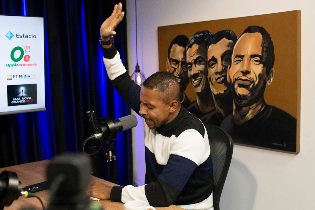 Ronaldo Pereira da Silva prays during the taping of the "01 Sobreviventes," or "01 Survivors" podcast in Rio de Janeiro, Tuesday, Aug. 25, 2026. (AP Photo/Bruna Prado)