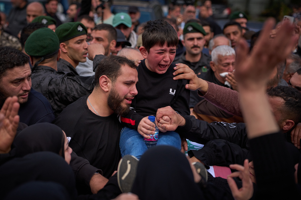 Mohammed, 8, weeps next to the coffin of his father, Hussein Makkah, during the funeral of 13 state security officers killed the previous day in an Israeli strike in Lebanon’s coastal city of Sidon, Lebanon, Saturday, April 11, 2026. (AP Photo/Emilio Morenatti)