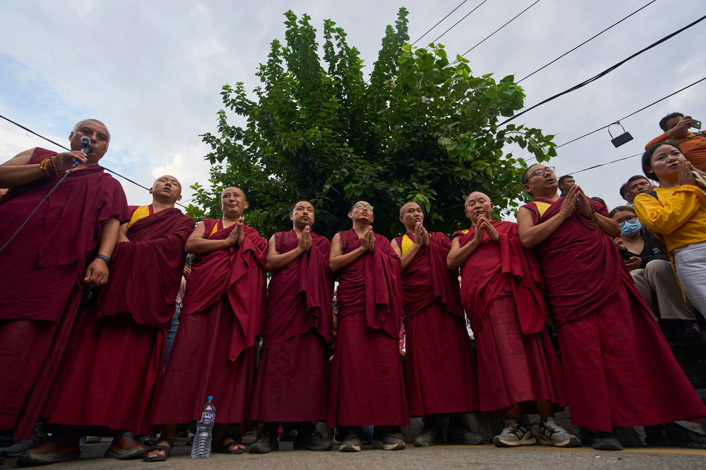 Monks chant religious mantras before lighting candles in memory of the climbers who died Thursday in an avalanche on Pakistan's Broad Peak, Kathmandu, Nepal, Tuesday, Aug. 4, 2026. (AP Photo/Niranjan Shrestha)