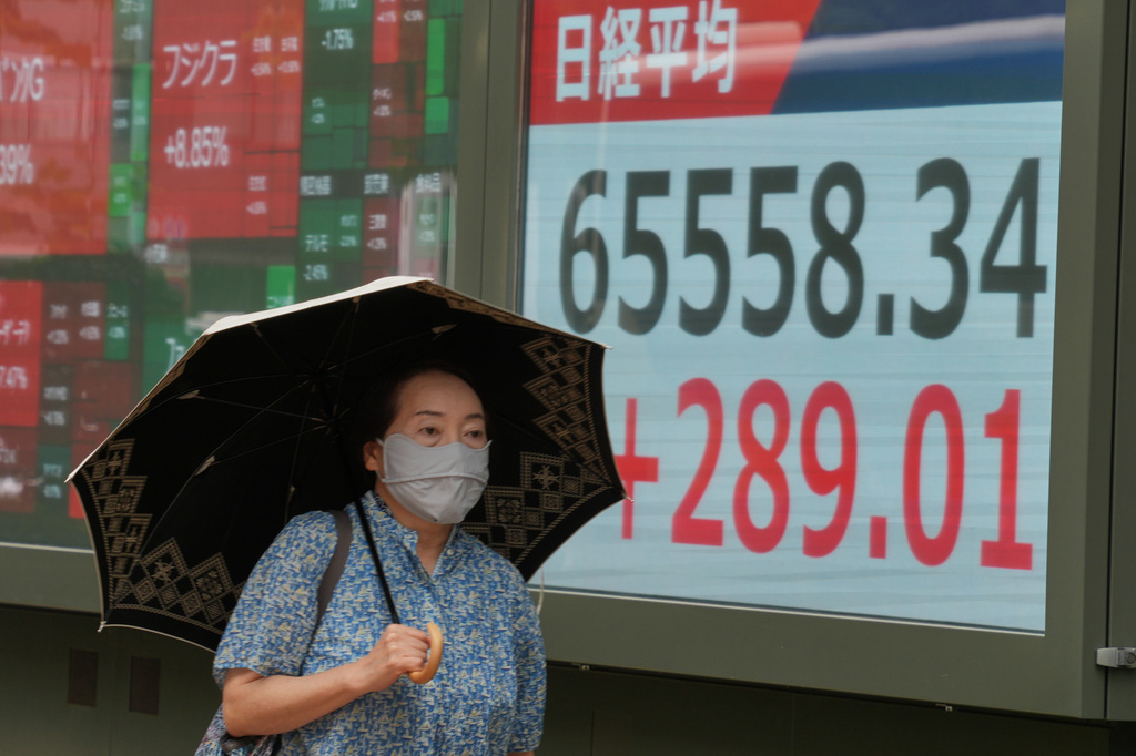 A person walks in front of an electronic stock board showing Japan's Nikkei index at a securities firm Wednesday, Sept. 9, 2026, in Tokyo. (AP Photo/Eugene Hoshiko)