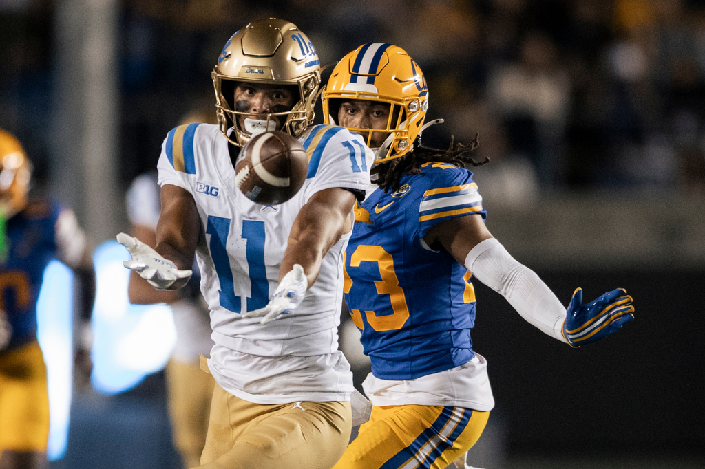 UCLA wide receiver Landon Ellis (11) misses a catch as California defensive back Isaiah Crosby (23) pressures during the first half of an NCAA football game in Berkeley, Calif., on Saturday, Sept. 5, 2026. (Stephen Lam/San Francisco Chronicle via AP)