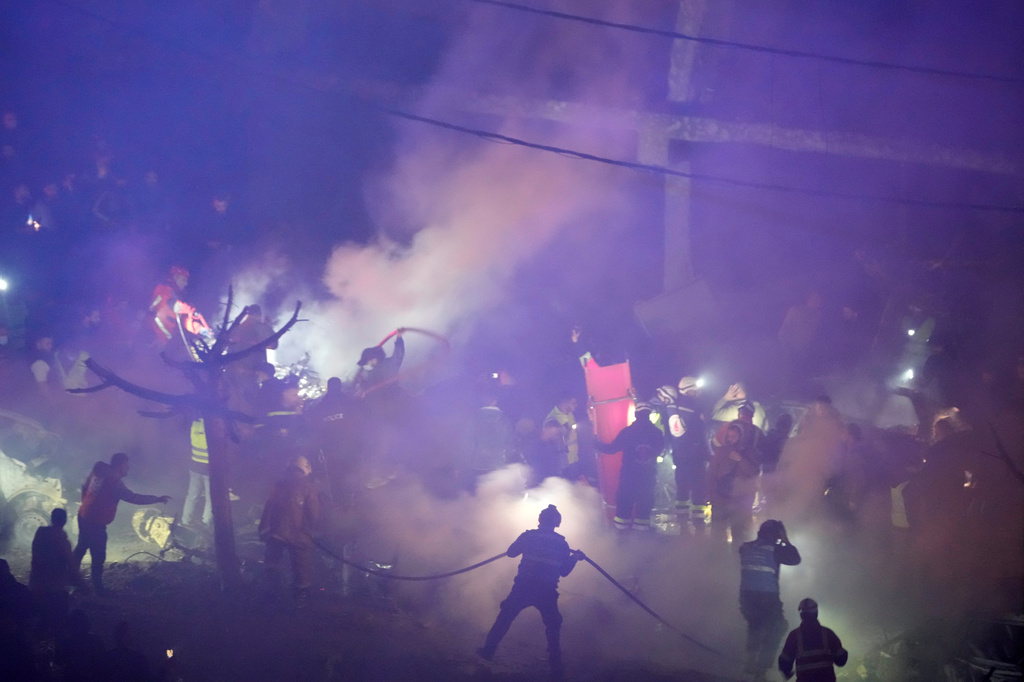 Firefighters and rescue workers work at the site of Israeli airstrikes, in Beirut, Lebanon, Wednesday, April 1, 2026. (AP Photo/Hussein Malla)