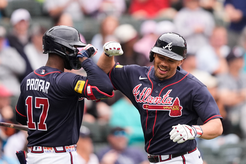 Atlanta Braves Drake Baldwin is greeted by Jurickson Profar after hitting a solo home run in the third inning of a spring training baseball game against the Minnesota Twins in North Port, Fla., Sunday, Feb. 22, 2026. (AP Photo/Gerald Herbert)