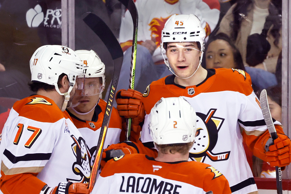 Anaheim Ducks Beckett Sennecke (45) celebrates after his goal against the Calgary Flames with teammates Alex Killorn (17), Mikael Granlund, second from left, and Jackson LaCombe (2) during second-period NHL hockey game action in Calgary, Alberta, Sunday, Jan. 25, 2026. (Larry MacDougal/The Canadian Press via AP)