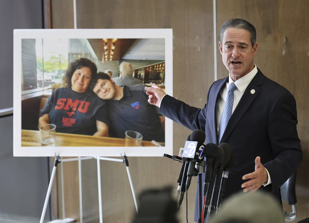 A photo of Sheryl Ferguson, the wife and son Phillip Ferguson of Orange County Superior Judge Jeffrey Ferguson is displayed as Orange County District Attorney Todd Spitzer speaks to the media after Orange County Superior Court Judge Jeffrey Ferguson was sentenced to 35 years to life in prison after his second-degree murder conviction for shooting his wife following an argument at the Central Justice Center in Santa Ana, Calif., Wednesday, Sept. 17, 2025. (Allen J. Schaben/Los Angeles Times via AP, Pool)