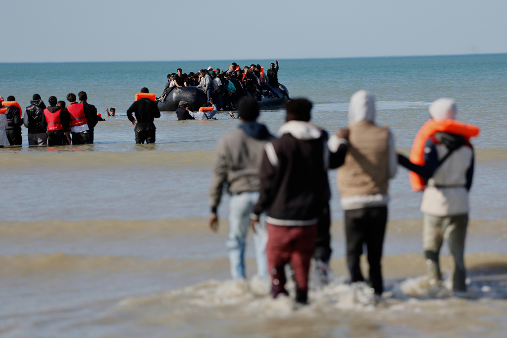 FILE - Migrants board a small boat to reach Britain on Sept. 19, 2025, in Gravelines, France. (AP Photo/Jean-Francois Badias, File)