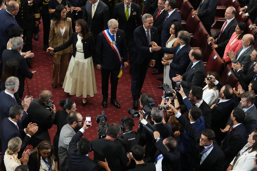 Chile's President Jose Antonio Kast, center, and his wife Maria Pia Adriasola greet guests on his inauguration day at Congress in Valparaiso, Chile, Wednesday, March 11, 2026. (AP Photo/Esteban Felix)
