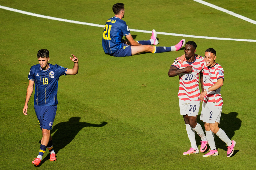 United States' Folarin Balogun (20) celebrates with Sergino Dest (2) after scoring their first goal as Bosnia's Kerim Alajbegovic (19) and Bosnia's Stjepan Radeljic (21) react during the World Cup round of 32 soccer match between the United States and Bosnia in Santa Clara, Calif., near San Francisco, Wednesday, July 1, 2026. (AP Photo/Jeff Chiu)