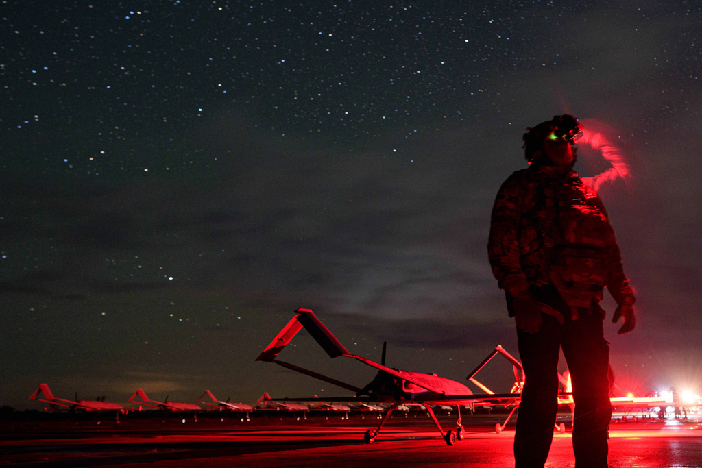 A Ukrainian commander, callsign Fidel of the 14th Separate Unmanned Aerial Systems Regiment, looks through night vision before takeoff, long-range drones An-196 Liutyi towards Russia in an undisclosed location, Ukraine, Tuesday, Oct. 14, 2025. (AP Photo/Evgeniy Maloletka)