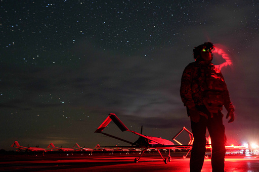 A Ukrainian commander, callsign Fidel of the 14th Separate Unmanned Aerial Systems Regiment, looks through night vision before takeoff, long-range drones An-196 Liutyi towards Russia in an undisclosed location, Ukraine, Tuesday, Oct. 14, 2025. (AP Photo/Evgeniy Maloletka) A Ukrainian commander, callsign Fidel of the 14th Separate Unmanned Aerial Systems Regiment, looks through night vision before takeoff, long-range drones An-196 Liutyi towards Russia in an undisclosed location, Ukraine, Tuesday, Oct. 14, 2025. (AP Photo/Evgeniy Maloletka)
