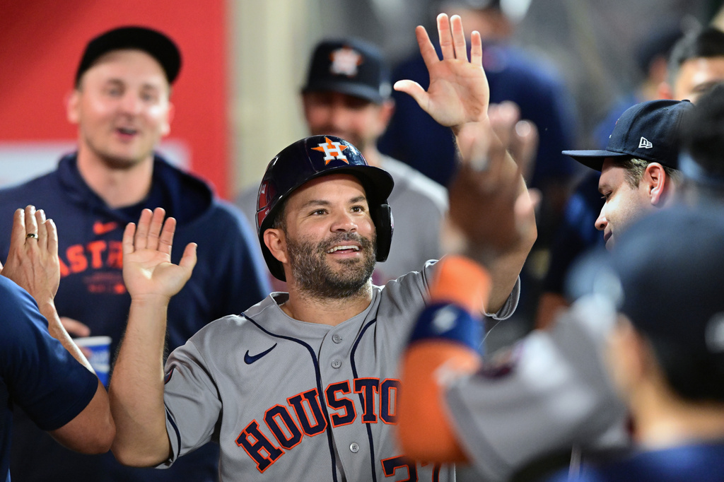 Houston Astros Jose Altuve (27) celebrates after scoring a run against the Los Angeles Angels during the seventh inning of a baseball game Wednesday, July 29, 2026, in Anaheim, Calif. (AP Photo/Wally Skalij)