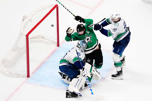 Dallas Stars center Tyler Seguin (91) pressures the net as Vancouver Canucks' Thatcher Demko (35) and Filip Chytil (72) defend against a shot in the third period of an NHL hockey game Thursday, Oct. 16, 2025, in Dallas. (AP Photo/Tony Gutierrez) Dallas Stars center Tyler Seguin (91) pressures the net as Vancouver Canucks' Thatcher Demko (35) and Filip Chytil (72) defend against a shot in the third period of an NHL hockey game Thursday, Oct. 16, 2025, in Dallas. (AP Photo/Tony Gutierrez)