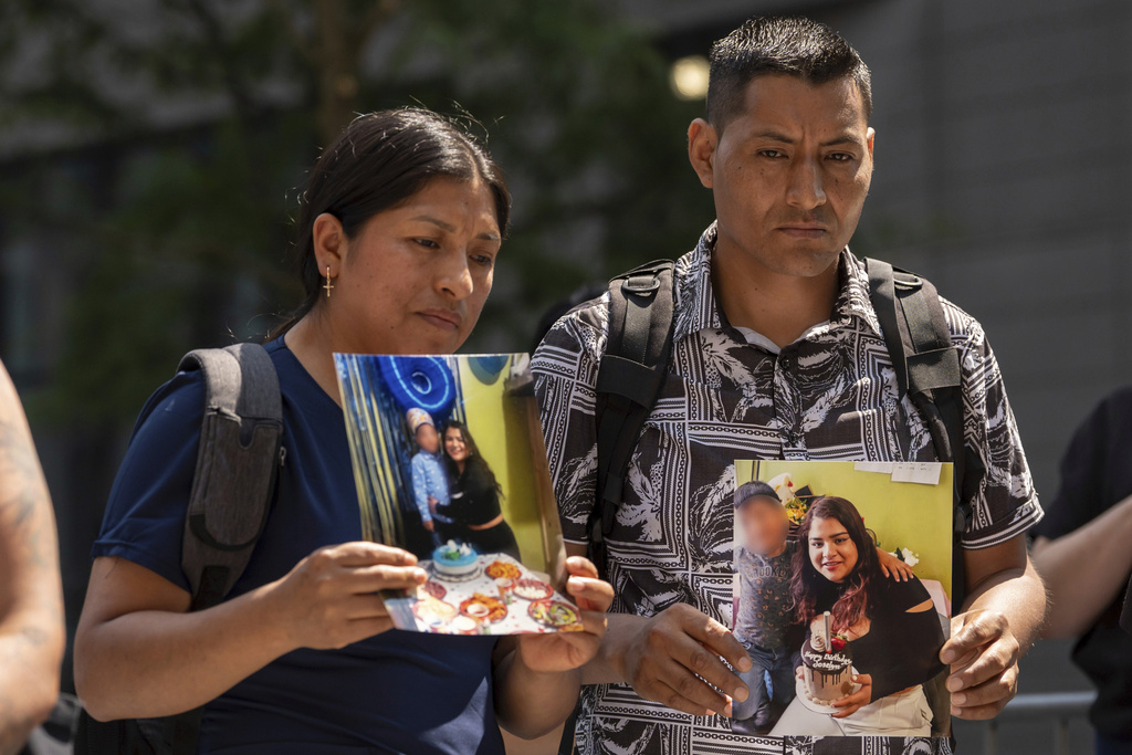 FILE - Marco Chipantiza, right, and Maria Chipantiza, left, an Ecuadorian immigrant couple, hold pictures of their daughter, Joselyn, 20, an Ecuadorian asylum seeker, with her 6-year-old son, during a press conference outside the Jacob K. Javits federal building on July 3, 2025, in New York. (AP Photo/Yuki Iwamura, File)