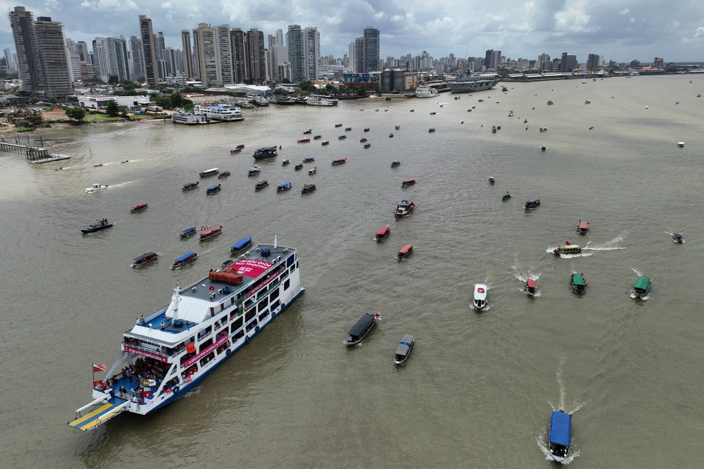 People riding in boats participate in a People's Summit event on Guajara Bay during the COP30 U.N. Climate Summit, Wednesday, Nov. 12, 2025, in Belem, Brazil. (AP Photo/Andre Penner)
