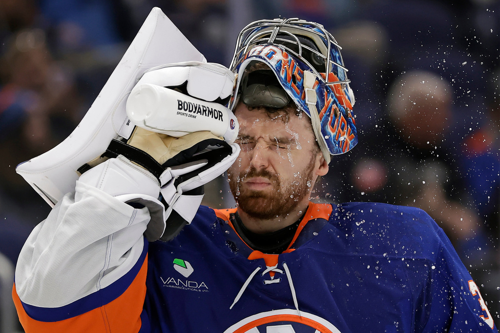 New York Islanders goaltender Ilya Sorokin sprays water on his face in the third period of an NHL hockey game against the Boston Bruins, Wednesday, Nov. 26, 2025, in Elmont, N.Y. (AP Photo/Adam Hunger)