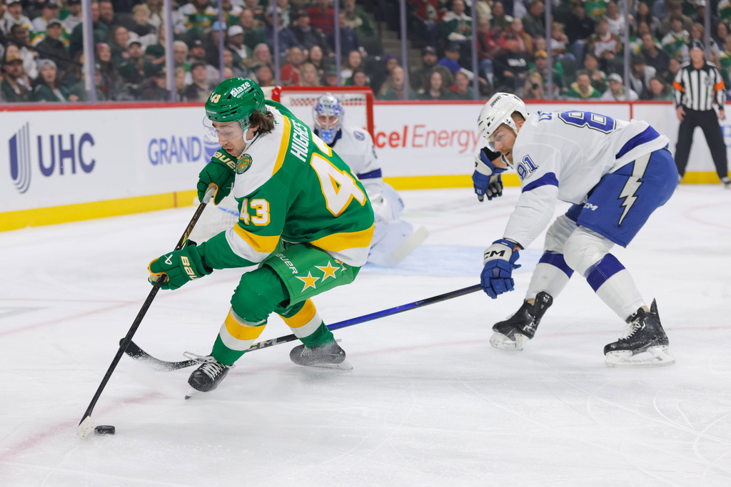 Minnesota Wild defenseman Quinn Hughes (43) skates with the puck while Tampa Bay Lightning defenseman Erik Cernak (81) defends during the first period of an NHL hockey game, Tuesday, March 3, 2026, in St. Paul, Minn. (AP Photo/Bailey Hillesheim)