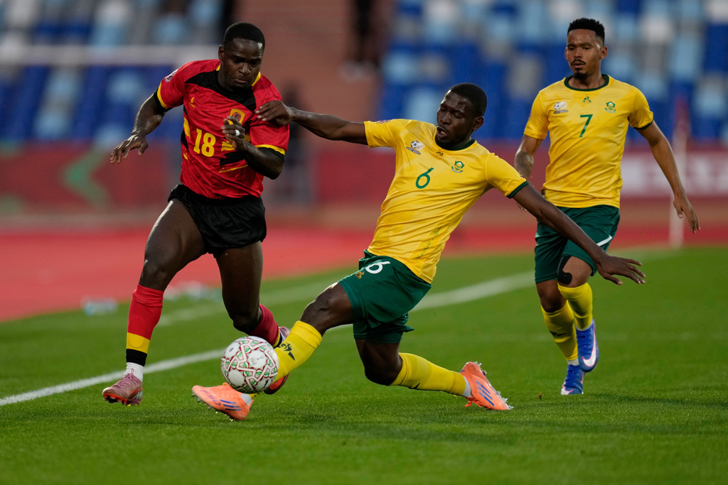 Angola's Zito Luvumbo, left, is challenged by South Africa's Aubrey Modiba during the Africa Cup of Nations group B soccer match between Angola and South Africa in Marrakech, Morocco, Monday, Dec. 22, 2025. (AP Photo/Themba Hadebe)