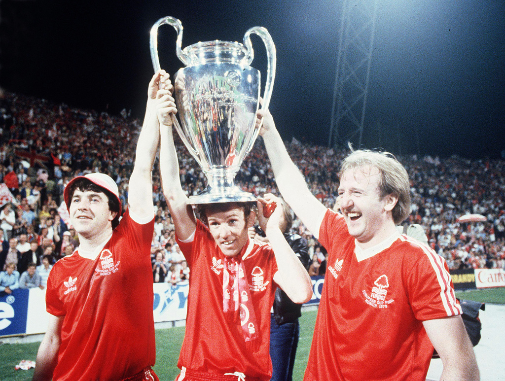 FILE - Nottingham Forest's John Robertson, left, Ian Bowyer, center, and Kenny Burns, right, carry the European Cup in triumph after their 1-0 win against Malmo FF in Munich, Germany, May 30, 1979. (AP Photo, File)