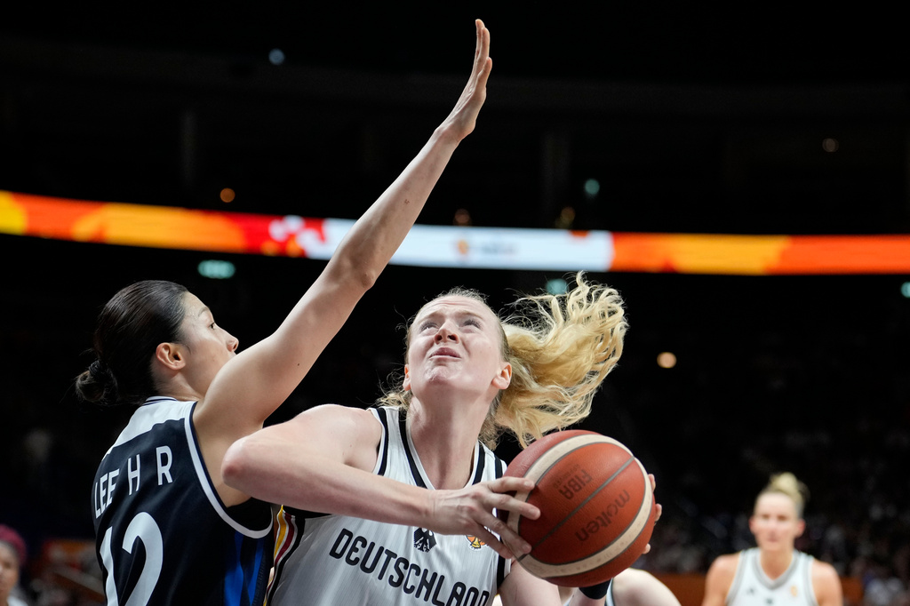 Germany's Marie Gülich, right, and Korea's Lee Hae-ran in action during the Women's Basketball World Cup qualification playoff between Germany and Korea in Berlin, Tuesday, Sept. 8, 2026. (AP Photo/Ebrahim Noroozi)