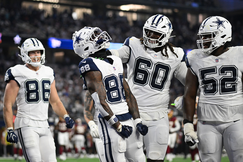 Dallas Cowboys wide receiver Ceedee Lamb (88) celebrates with offensive tackle Tyler Guyton (60) and guard Tyler Booker (52) after scoring a touchdown against the Washington Commanders in the second half during an NFL football game in Arlington, Texas, Sunday, Sept. 20, 2026. (AP Photo/Jessica Tobias)
