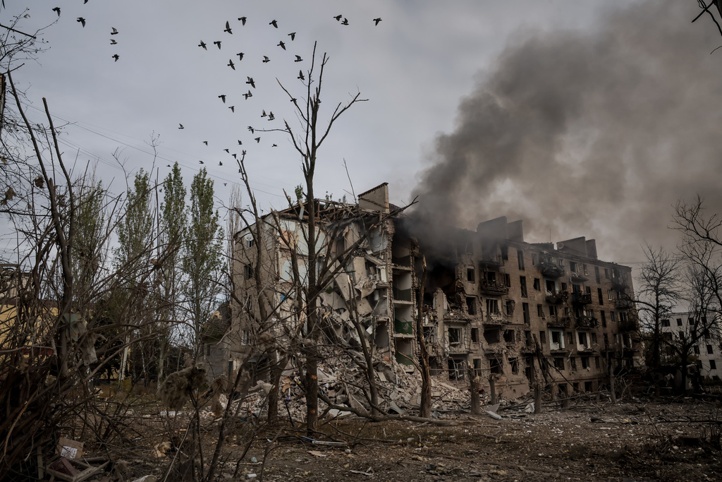 In this photo taken on Oct.13, 2025 and provided by Ukraine's 24th Mechanized Brigade press service, crows fly over the ruins and smoke in Kostiantynivka, a frontline town where some 5000 people still stay with no water, electricity and gas supply in the site of heaviest battles with the Russian troops in the Donetsk region, Ukraine. (Oleg Petrasiuk/Ukraine's 24th Mechanized Brigade via AP)