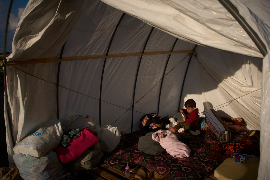 Alongside her brother Khalid, 15-day-old Shaiman sleeps in the tent where she was born, which the family is using as a shelter in Beirut, Sunday, April 12, 2026. (AP Photo/Emilio Morenatti)
