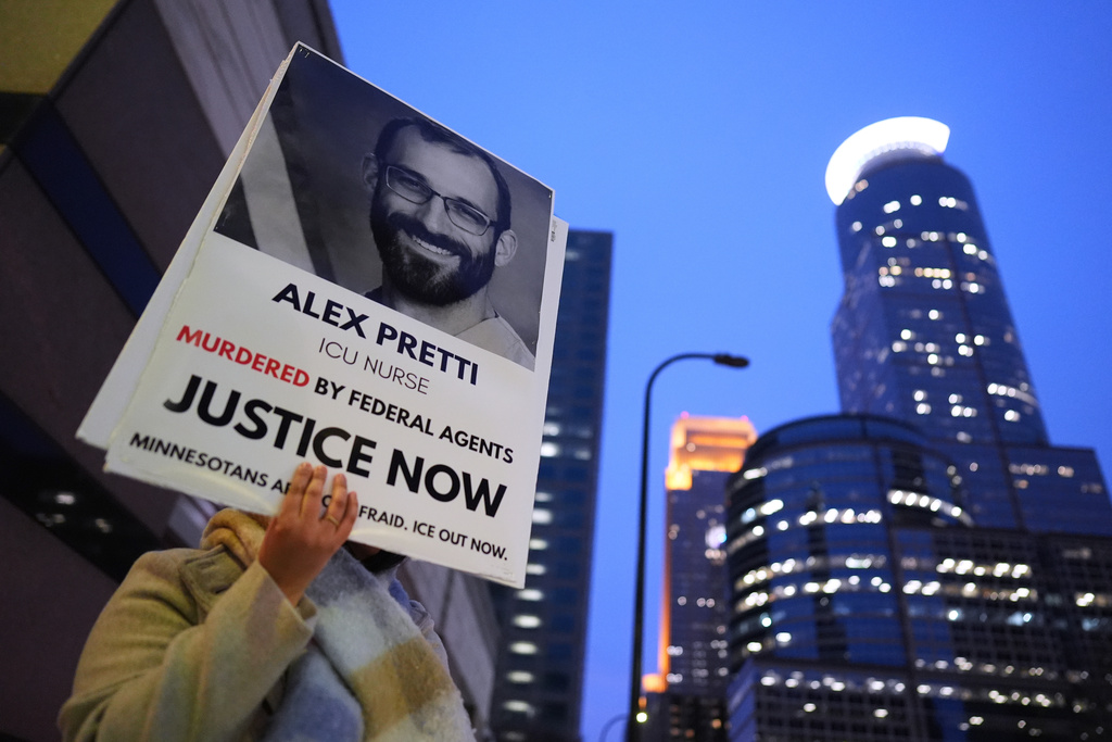 A person holds a sign of Alex Pretti during a protest outside the office of Sen. Amy Klobuchar, D-Minn., on Monday, Jan. 26, 2026, in Minneapolis. (AP Photo/Adam Gray)