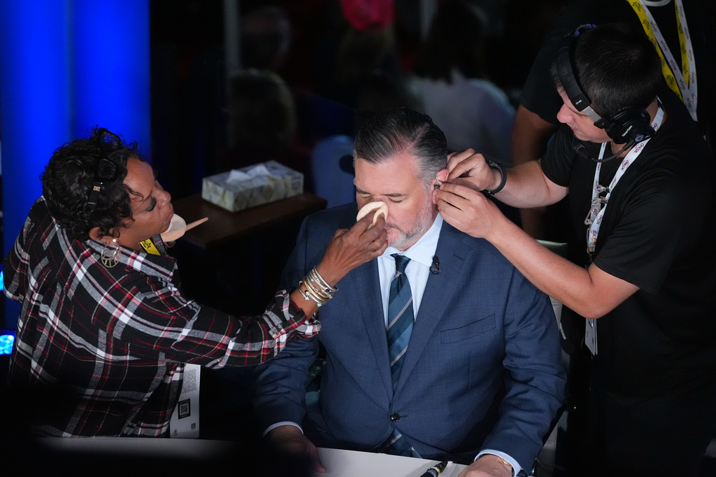 Backstage personnel prepare U.S. Sen. Ted Cruz for a televised appearance at the Republican convention in Dallas, Wednesday, Sept. 9, 2026. (AP Photo/Tony Gutierrez)