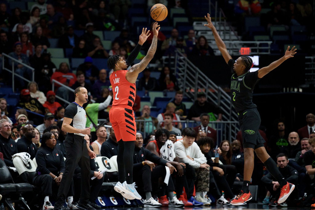Portland Trail Blazers guard Caleb Love (2) shoots against New Orleans Pelicans forward Herbert Jones (2) during the first half of an NBA basketball game in New Orleans, Thursday, Dec. 11, 2025. (AP Photo/Matthew Hinton)