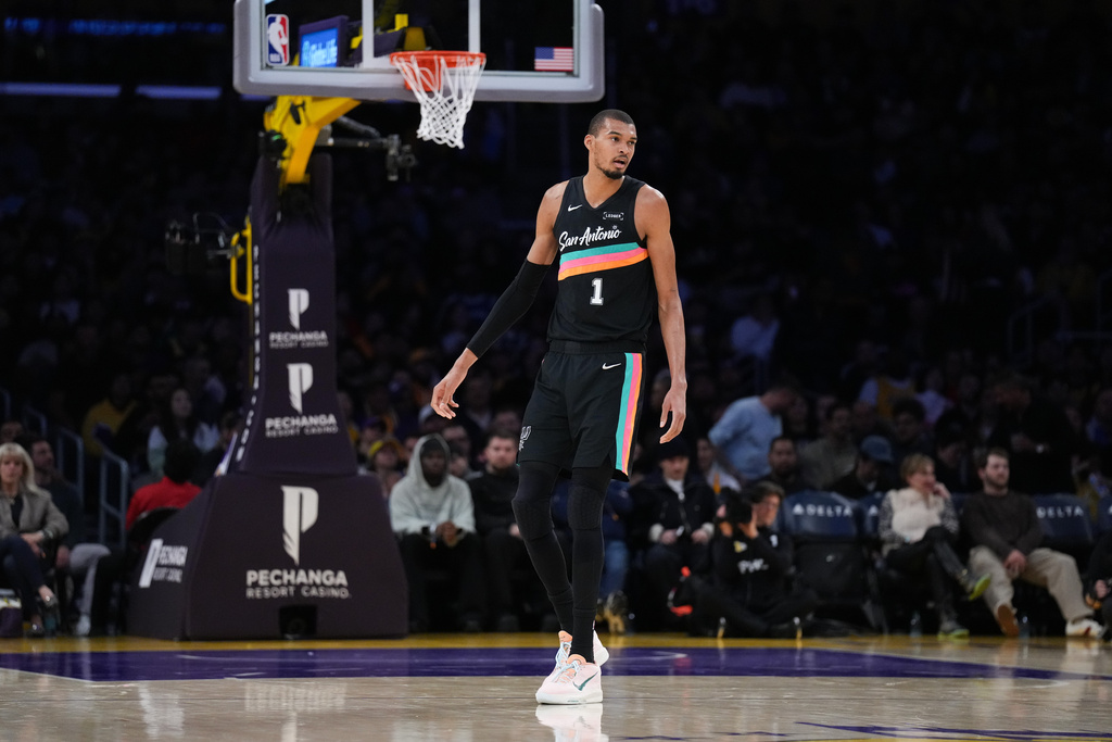 San Antonio Spurs forward Victor Wembanyama (1) watches action during the first half of an NBA basketball game against the Los Angeles Lakers Tuesday, Feb. 10, 2026, in Los Angeles. (AP Photo/Jae C. Hong)