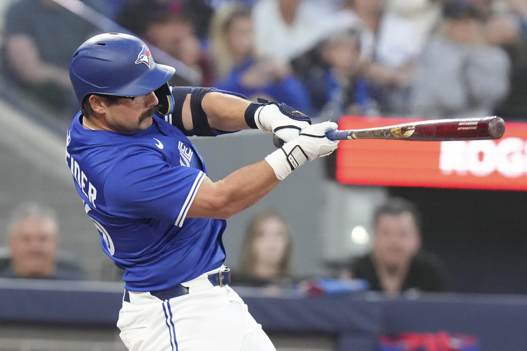 Toronto Blue Jays' Davis Schneider hits a solo home run against the Minnesota Twins the second inning of a baseball game in Toronto on Wednesday, Aug. 27, 2025. (Chris Young/The Canadian Press via AP)