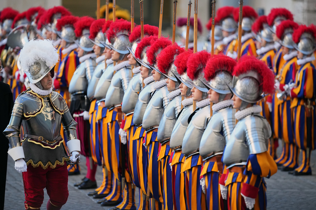 Pontifical Swiss Guard's 35th Commander Christoph Graf, left, review 27 Pontifical Swiss Guards cadets during their swearing in ceremony in the St. Damasus courtyard at the Vatican, Saturday, Oct. 4, 2025. (AP Photo/Andrew Medichini)