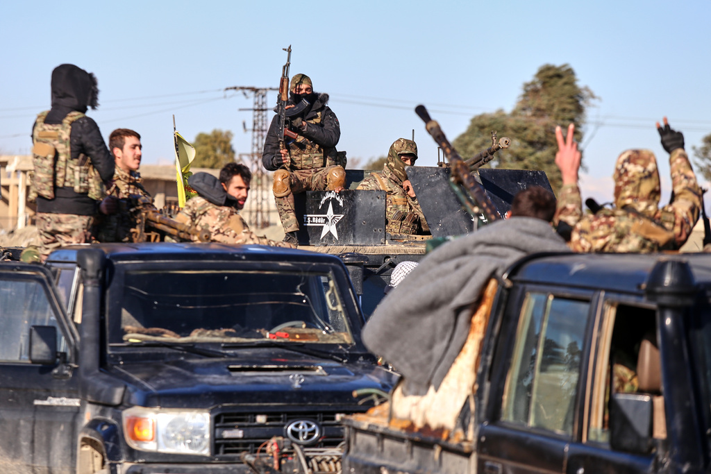 Soldiers of the Kurdish-led, U.S.-backed Syrian Democratic Forces (SDF) deploy with armoured military vehicles to secure roads leading to Gweiran Prison which houses men accused of being an Islamic State (ISIS) fighters in Hassakeh, northeastern Syria, Monday, Jan. 19, 2026. (AP Photo/Baderkhan Ahmad)