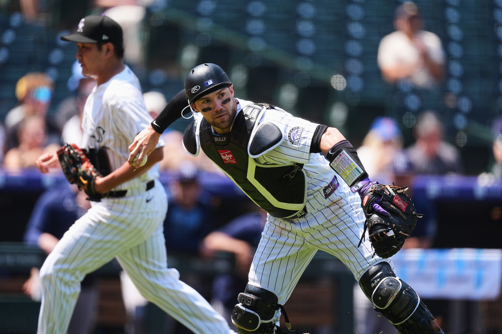 Colorado Rockies catcher Brett Sullivan throws to first base to put out Tampa Bay Rays' Cedric Mullins in the first inning of a baseball game in Denver, Wednesday, Aug. 5, 2026. (AP Photo/David Zalubowski)