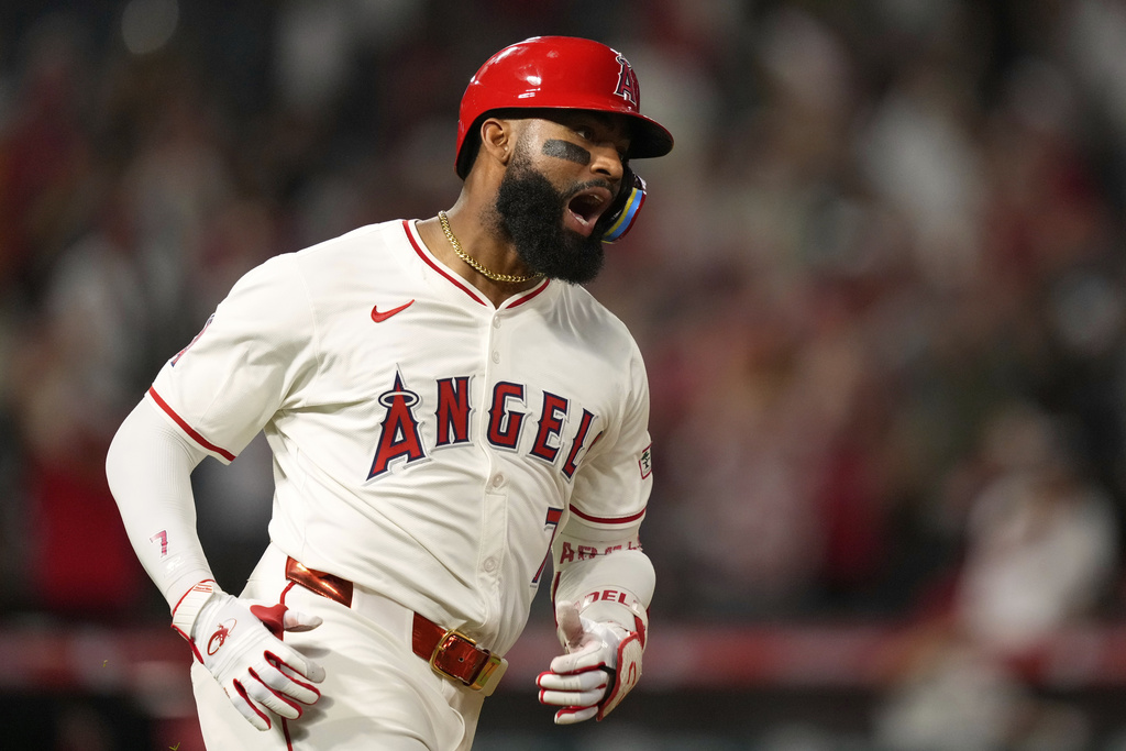 Los Angeles Angels' Jo Adell celebrates after hitting a solo home run during the eighth inning of a baseball game against the Cincinnati Reds, Tuesday, Aug. 19, 2025, in Anaheim, Calif. (AP Photo/Mark J. Terrill)