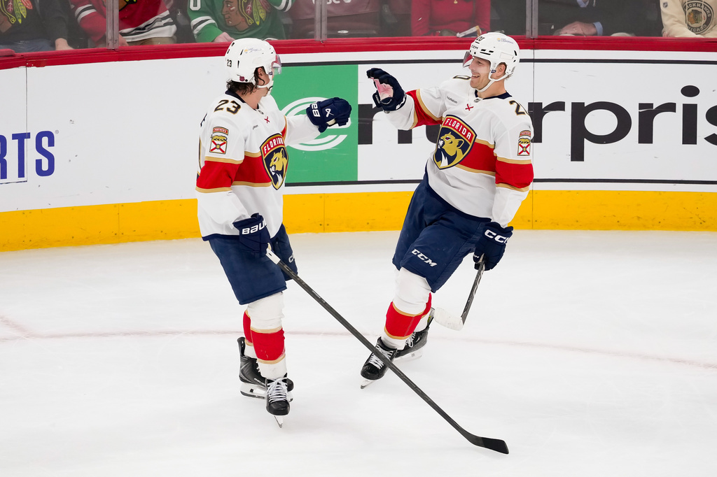 Florida Panthers center Lars Eller, right, celebrates with center Carter Verhaeghe, left, after scoring the winning goal during the third period of an NHL hockey game against the Chicago Blackhawks, Sunday, Oct. 25, 2026, in Chicago. (AP Photo/Harry Figiel)