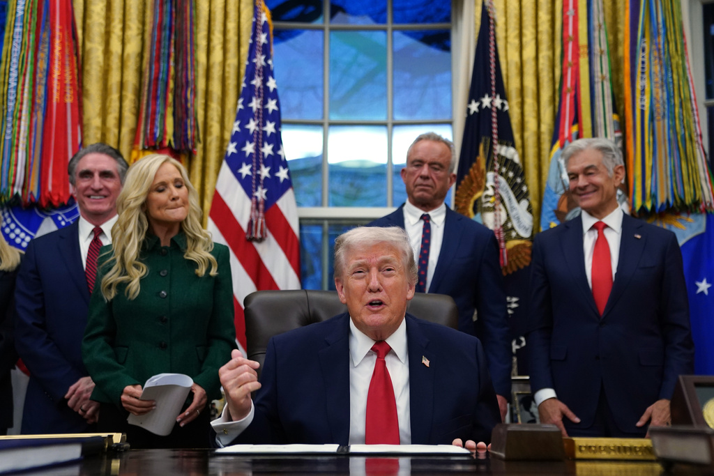 President Donald Trump speaks before signing an executive order on addiction recovery in the Oval Office of the White House, Thursday, Jan. 29, 2026, in Washington, as from left Interior Secretary Doug Burgum, Kathryn Burgum, Health and Human Services Secretary Robert F. Kennedy Jr. and Centers for Medicare & Medicaid Services administrator Dr. Mehmet Oz watch. (AP Photo/Allison Robbert)