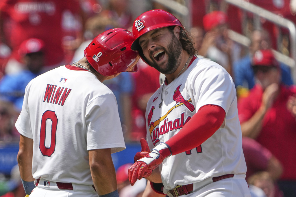 St. Louis Cardinals' Alec Burleson, right, is congratulated by teammate Masyn Winn (0) after hitting a two-run home run during the fifth inning of a baseball game against the Colorado Rockies Wednesday, Aug. 13, 2025, in St. Louis. (AP Photo/Jeff Roberson)
