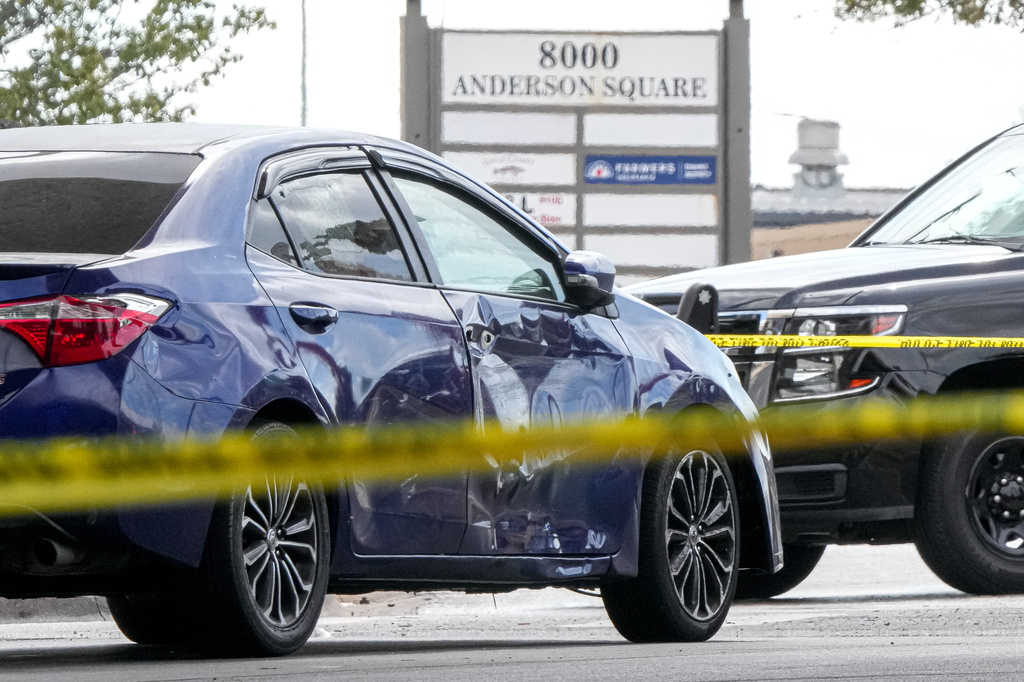 A vehicle with a damaged door and broken window is left in the street after a man was shot in his vehicle by an ICE officer, Sunday, Sept. 20, 2026, in Austin, Texas. (Aaron E. Martinez /Austin American-Statesman via AP)