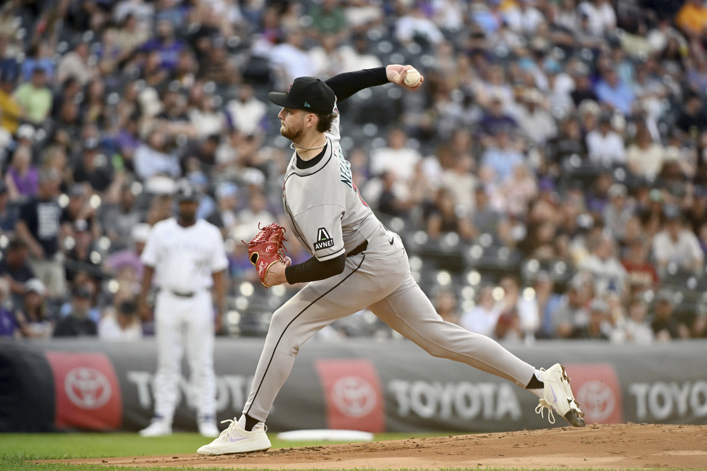 Arizona Diamondbacks starting pitcher Ryne Nelson throws in the first inning of a baseball game against the Colorado Rockies, Saturday, Aug. 16, 2025, in Denver. (AP Photo/Geneva Heffernan)