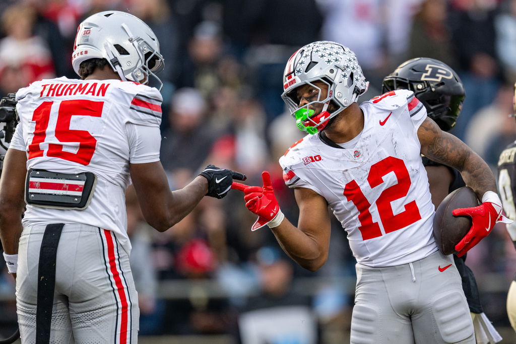 Ohio State running back CJ Donaldson Jr. (12) celebrates with tight end Jelani Thurman (15) after scoring during the second half of an NCAA college football game against Purdue, Saturday, Nov. 8, 2025, in West Lafayette, Ind. (AP Photo/Doug McSchooler)
